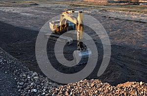 Excavator working on earthmoving at open pit mining. Backhoe digs gravel in quarry. Construction machinery for excavation, loading