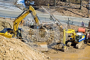 An excavator working on earthwork at a industrial site under infrastructure development