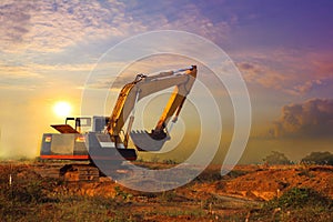 Excavator working and moving earth in construction afternoon