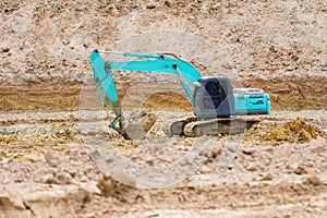 An excavator working removing earth on a construction site.