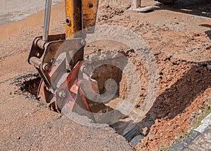 Excavator working the Repair of pipe water sewerage on road