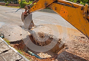 Excavator working the Repair of pipe water sewerage on road