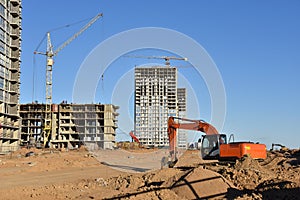 Excavator Working On Road Construction. Backhoe on Earthworks. Heavy Construction Equipment Machines. Big Red Digger at