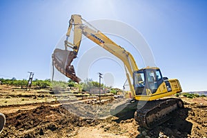 Excavator working on road.