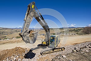 Excavator working on road.