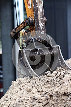 Excavator working on the sand at a construction site