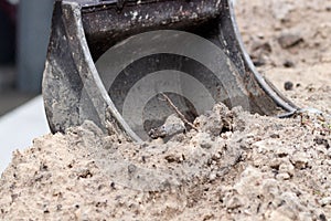 Excavator working on the sand at a construction site