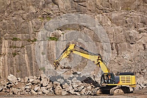 Excavator working on a stone quarry. Geological excavation equipment