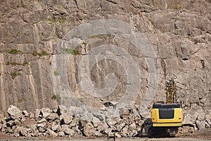 Excavator working on a stone quarry. Geological excavation equipment