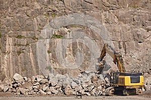 Excavator working on a stone quarry. Geological excavation equipment