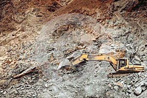 Excavator working and unloading earth soil and rocks..industrial bulldozer, excavator and track type excavator working on construc