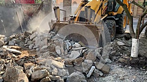 The excavator works on construction site to prepare the backyard of a private house for renovation.