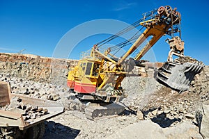 excavator works with granite or ore at opencast mining