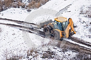 Excavator works in mud on construction site