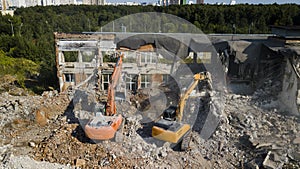 Excavators demolish building. Drone view