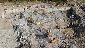 Excavators demolish building. Drone view