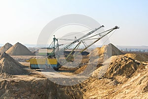 Excavators draglines in the clay quarry