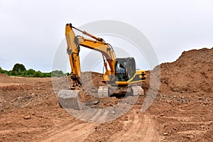 Excavators during earthworks at construction site. Backhoe the digging pit for construct building foundation. Paving out sewer