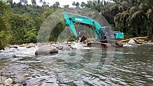 Excavators are working in the middle of the river.