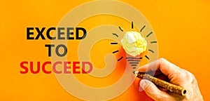 Exceed to succeed symbol. Concept words Exceed to succeed on beautiful orange paper. Beautiful orange background. Light bulb icon