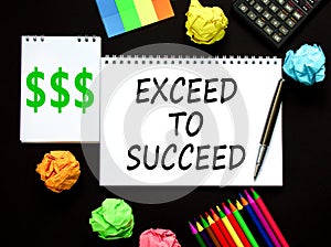 Exceed to succeed symbol. Concept words Exceed to succeed on beautiful white note. Beautiful black background. Black pen. Colored