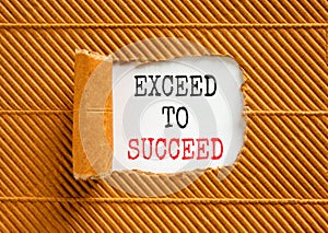 Exceed to succeed symbol. Concept words Exceed to succeed on beautiful white paper. Beautiful brown paper background. Business and