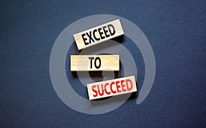 Exceed to succeed symbol. Concept words Exceed to succeed on beautiful wooden blocks. Beautiful black table black background.