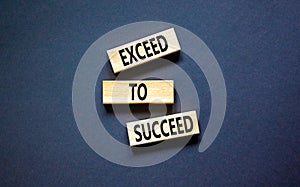 Exceed to succeed symbol. Concept words Exceed to succeed on beautiful wooden blocks. Beautiful black table black background.