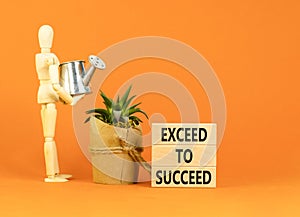 Exceed to succeed symbol. Concept words Exceed to succeed on beautiful wooden blocks. Beautiful orange table orange background.