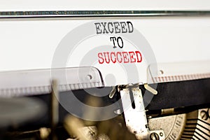 Exceed to succeed symbol. Concept words Exceed to succeed typed on beautiful old retro typewriter. Beautiful white paper