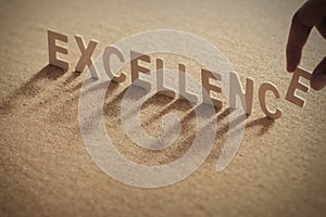 EXCELLENCE wood word