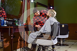 Excellent barber does not rush haircut. Visit hairdresser. Beauty routine. Maintaining shape. Man sit barber chair