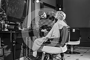 Excellent barber does not rush haircut. Visit hairdresser. Beauty routine. Maintaining shape. Man sit barber chair