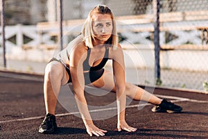 Excellent exercise! A young, beautiful sports girl in sport clothing doing lunges