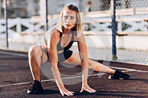 Excellent exercise! A young, beautiful sports girl in sport clothing doing lunges