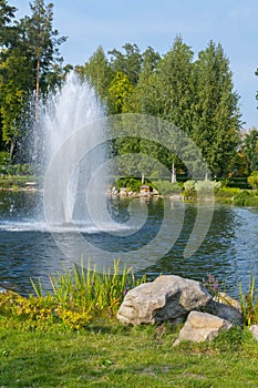 Excellent fountain in the middle of a small pond with stones on the shore