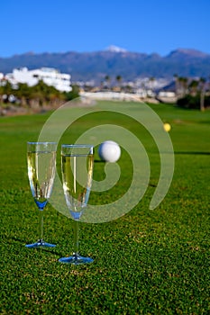 Excellent well-kept green grass lawn on large golf course, green section with big white foam balls for beginners on Tenerife