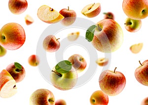 Excellently retouched multi colored apples with leaves whole halves and slices fly and levitate in space. Surround light from