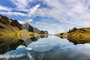 Exceptional view of alpine lake `Schrecksee` in the alps with symmetrical reflections in Bavaria, Germany