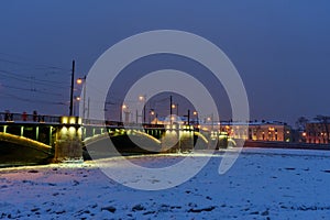 Exchange Bridge over frozen Malaya Neva River at night. Saint Petersburg. Russia