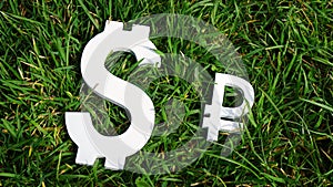 Exchange rate. The Russian ruble and the dollar sign on grass.