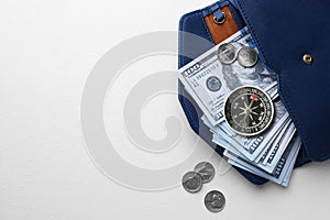 Exchange rate. Wallet with money (dollar banknotes and coins) and compass on white background, top view. Space for text