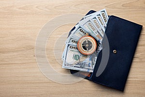 Exchange rate. Wallet with money (dollar banknotes) and compass on wooden background, top view. Space for text