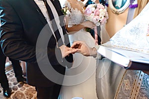 The exchange of rings during an Orthodox wedding, the priest wears the ring bride and groom, wedding day, the church