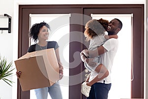 Excited African American family moving to new house photo