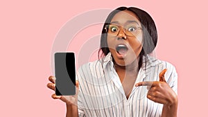 Excited African American Girl Holding Phone Pointing Finger, Studio, Mockup