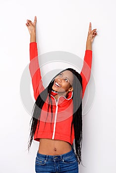 Excited african american girl pointing up on white background
