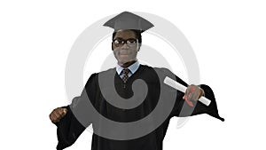 Excited african american male student in graduation robe dancing