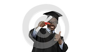 Excited african american male student in graduation robe waiving