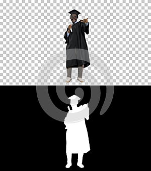 Excited african american male student in graduation robe waiving